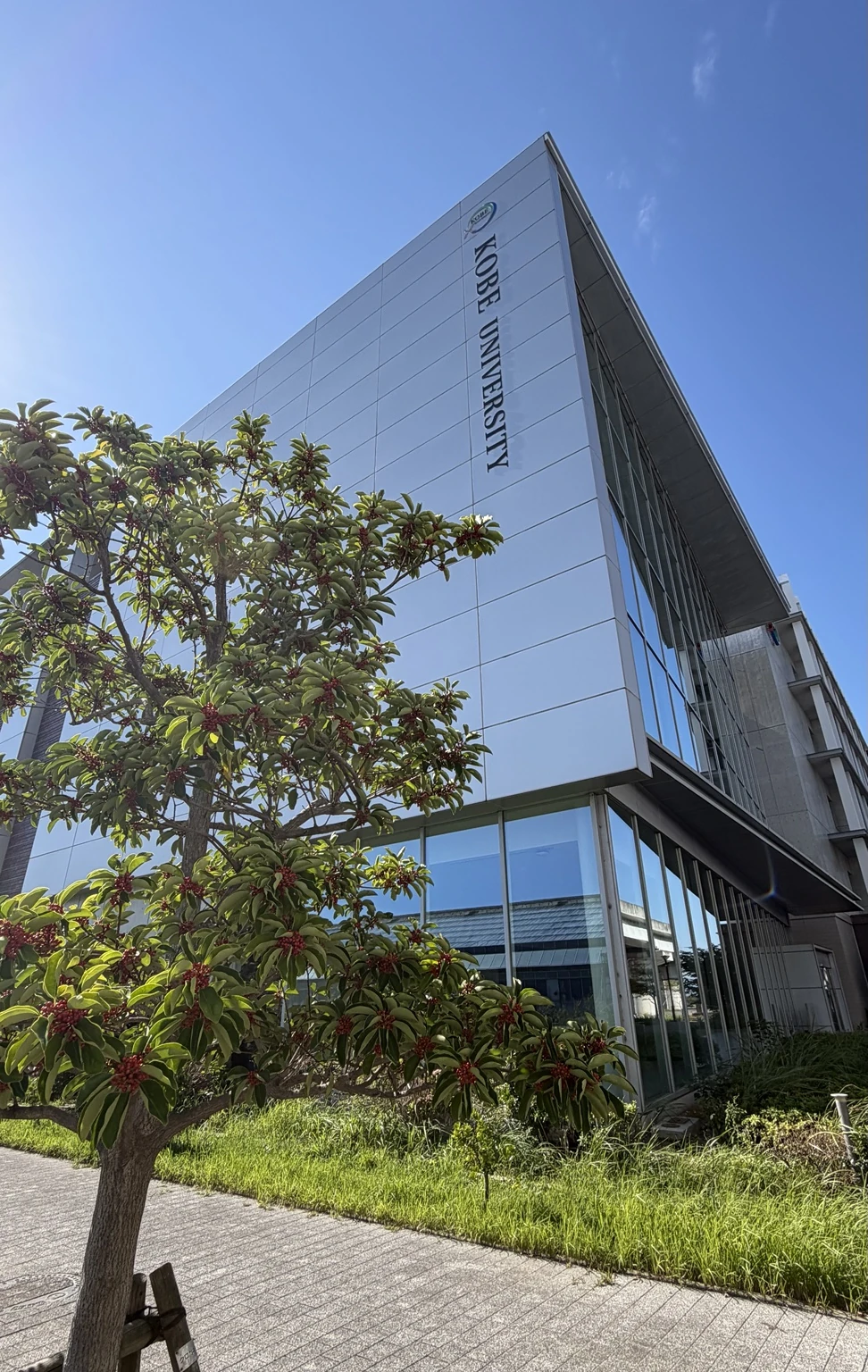 Kobe University building photographed beneath a clear blue sky